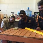 Looking busy: Men's Shed members Kale Johnson, Juhani Mursunen, Gary Hartman and Troy Wilde make a table from a crate. Photo: Chris Burns.